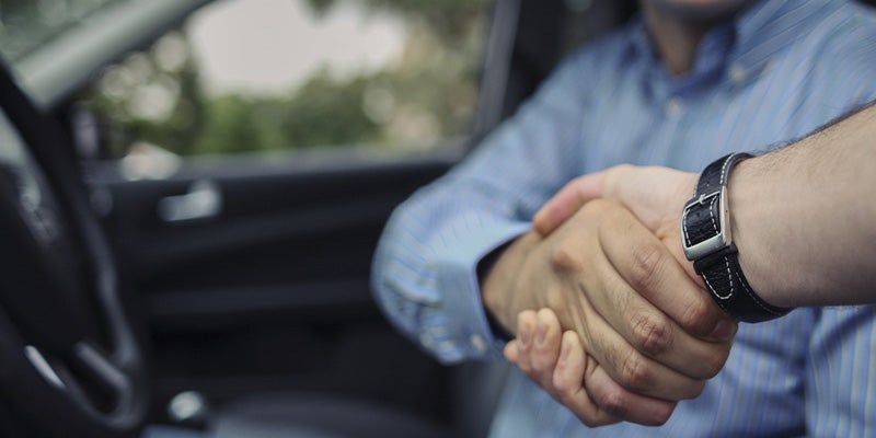 Spence Chevrolet GMC customer shaking hands with sales rep